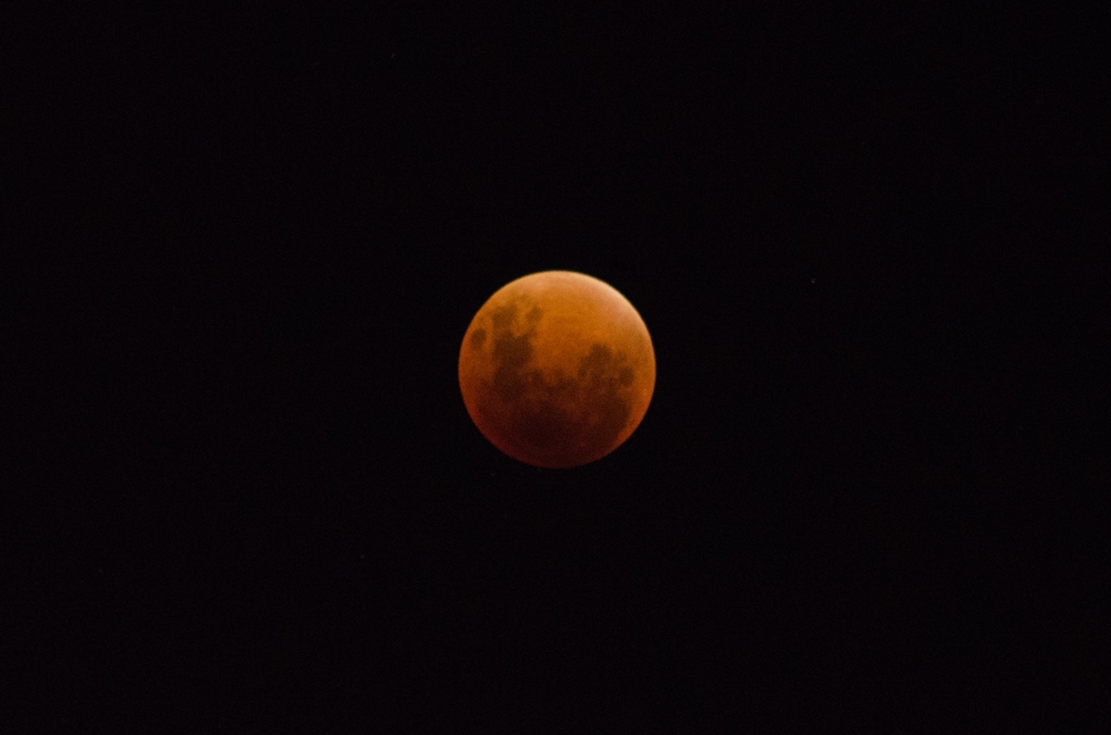 The red moon is rising behind you