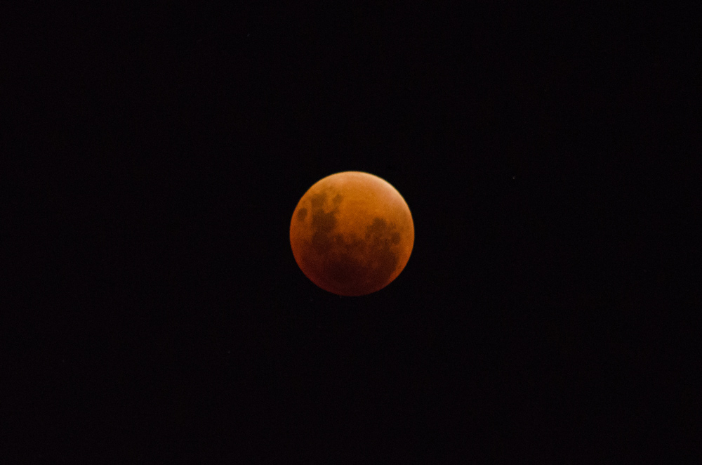 The red moon is rising behind you